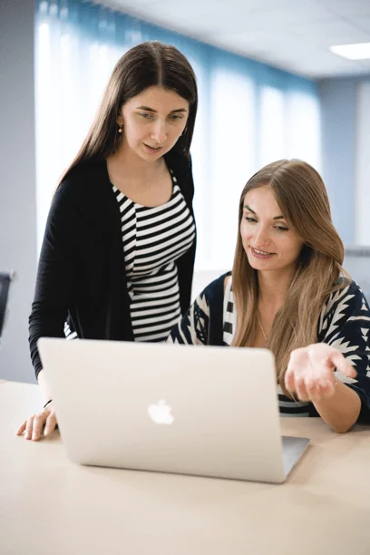 two designers working on the project and demonstrating project on the laptop’s screen