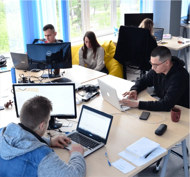 the dedicated development team working on their laptops at the office