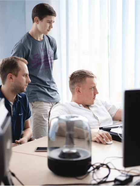 the members of dedicated development team are looking at the monitor
